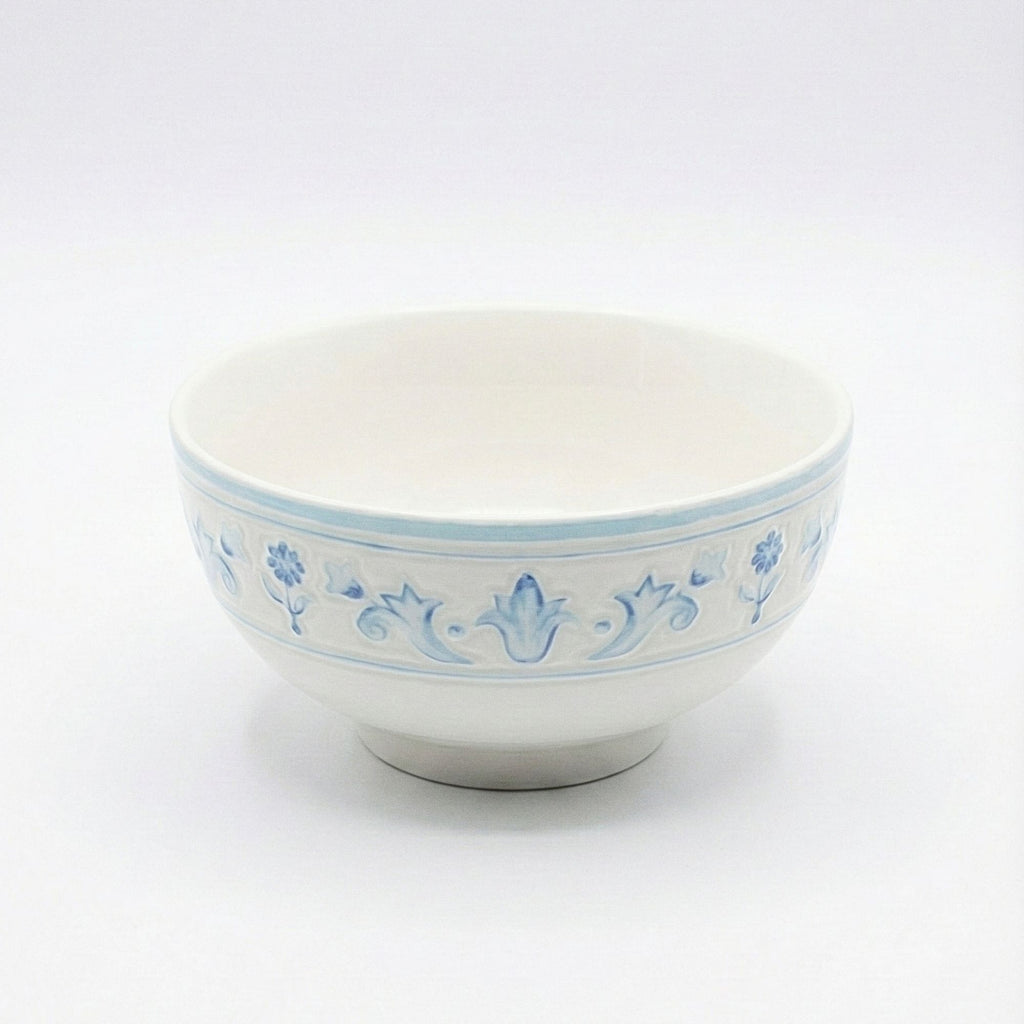 White ceramic bowl with blue floral patterns on a white background