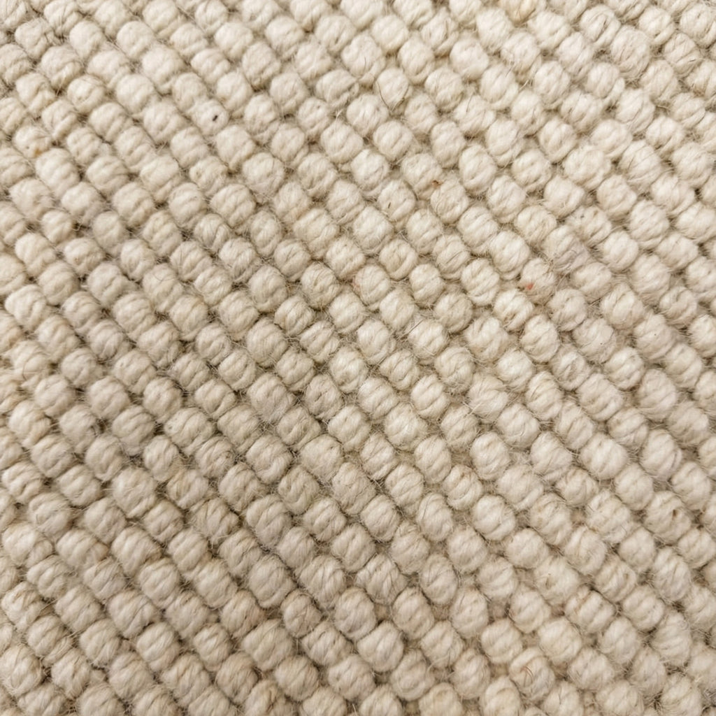 Close-up of textured beige fabric with diamond pattern