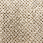 Close-up of textured beige fabric with diamond pattern