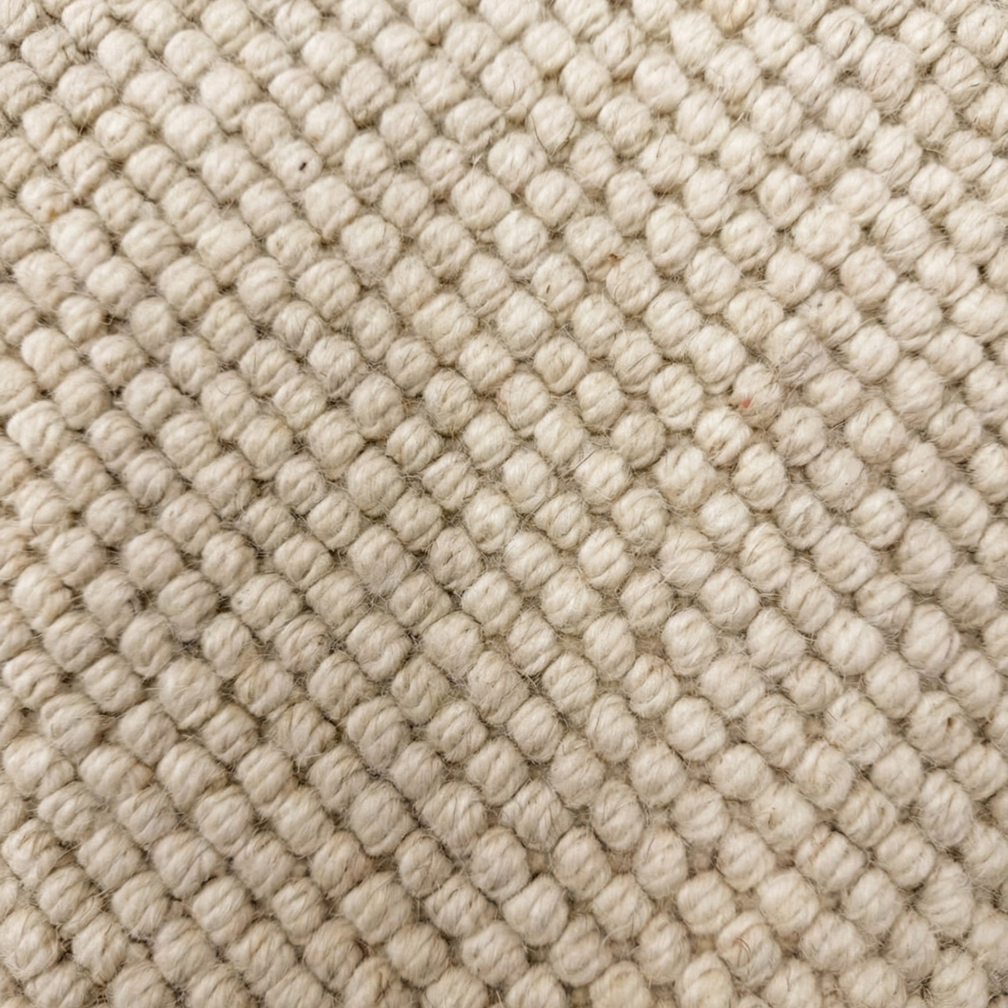Close-up of textured beige fabric with diamond pattern
