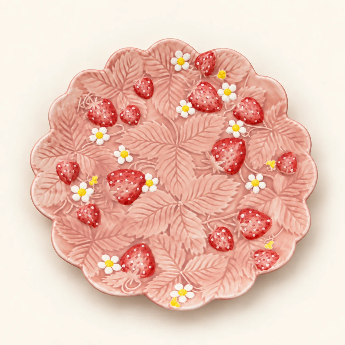 Overhead view of Berry Bloom scalloped salad plate with sculpted strawberries and white blossoms
