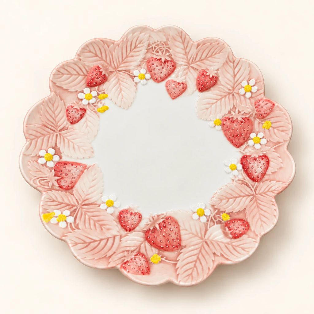 Overhead view of Berry Bloom dinner plate with sculpted pink leaves, strawberries and white blossoms
