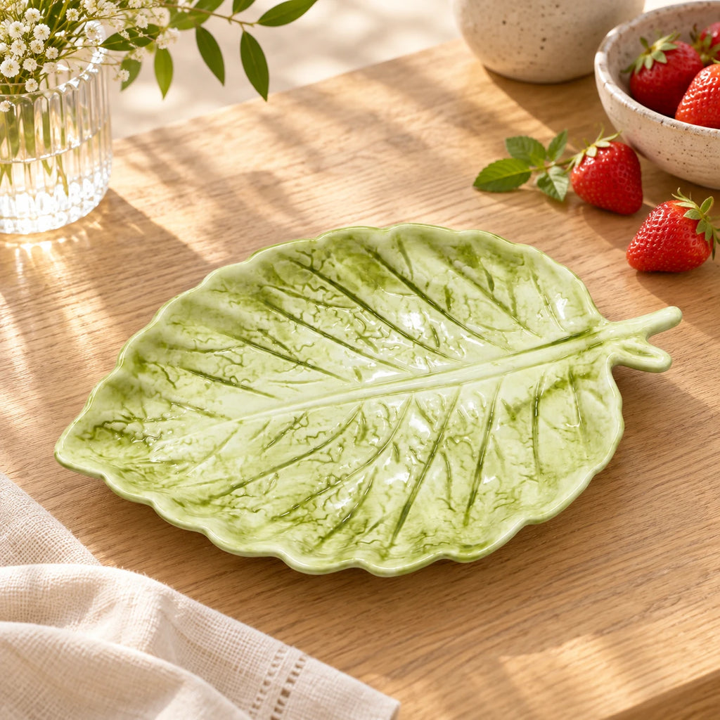 Berry Bloom green leaf plate styled on a table with fresh strawberries