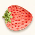 Overhead view of Berry Bloom strawberry-shaped plate with raised seed details