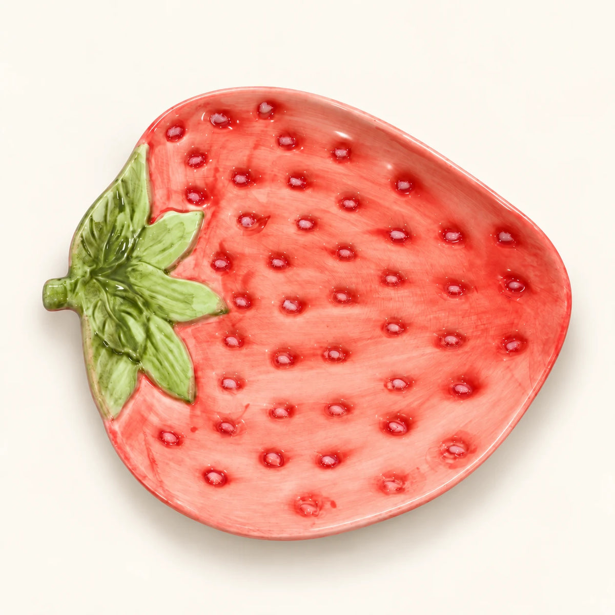 Overhead view of Berry Bloom strawberry-shaped plate with raised seed details