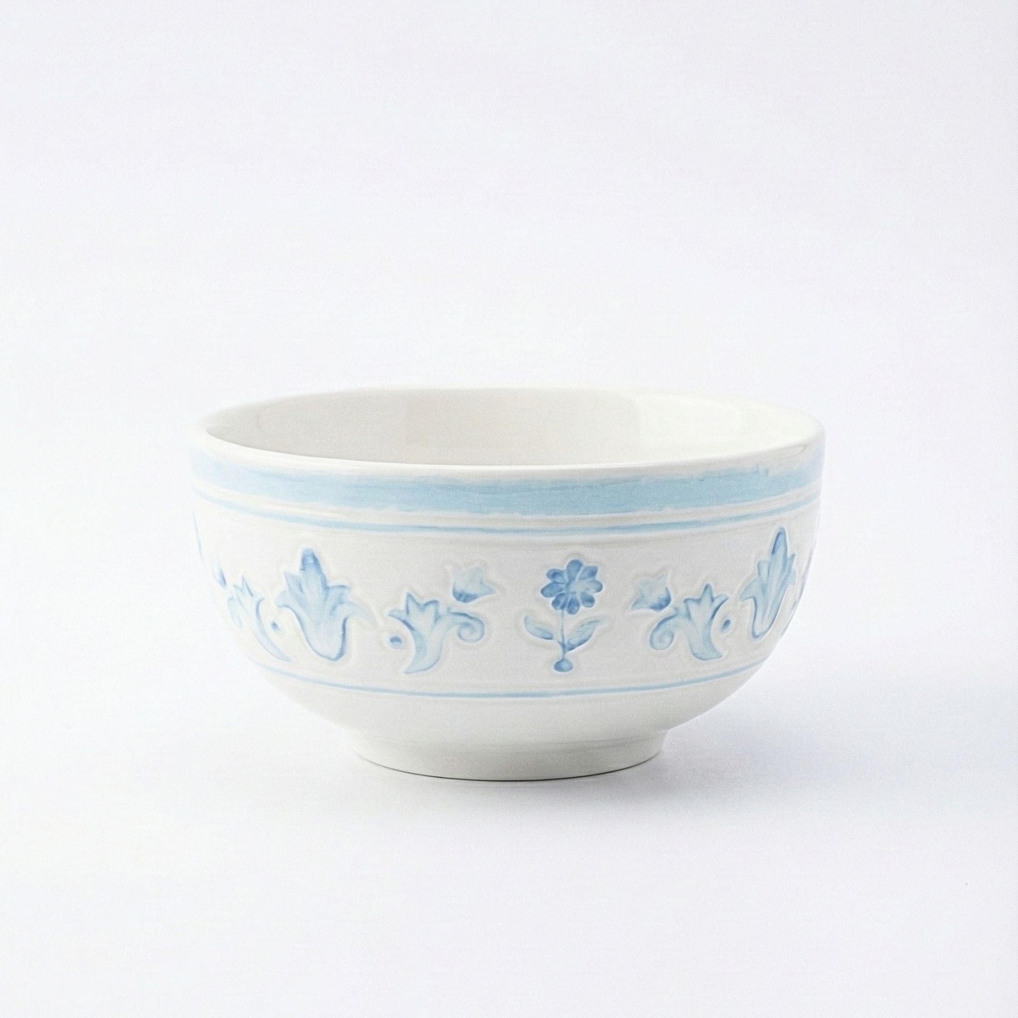 White ceramic bowl with blue floral patterns on a white background
