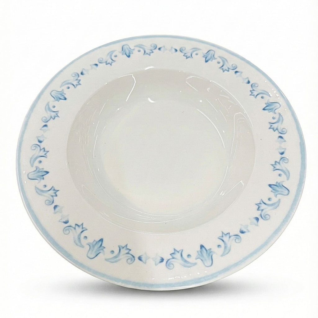 White ceramic bowl with blue floral patterns on a white background