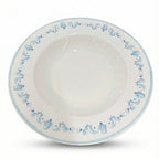 White ceramic bowl with blue floral patterns on a white background