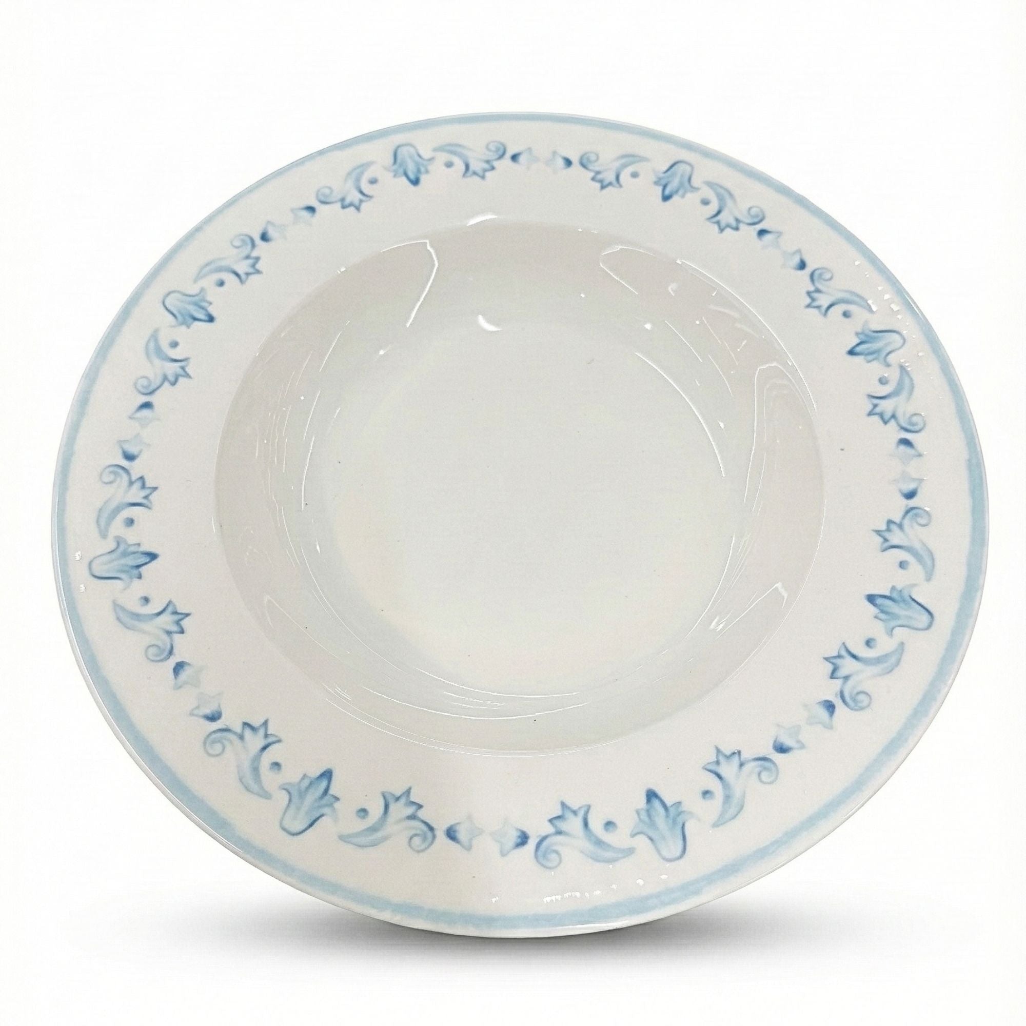 White ceramic bowl with blue floral patterns on a white background