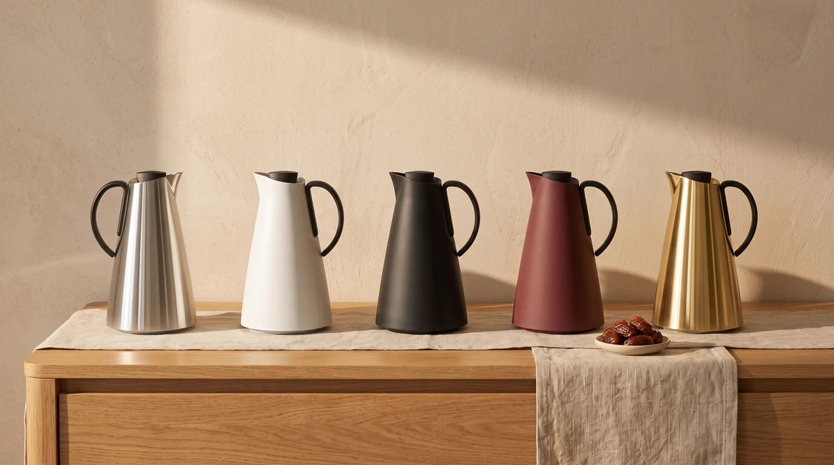 Adaman vacuum jugs in silver, white, black, burgundy and gold on a warm oak console